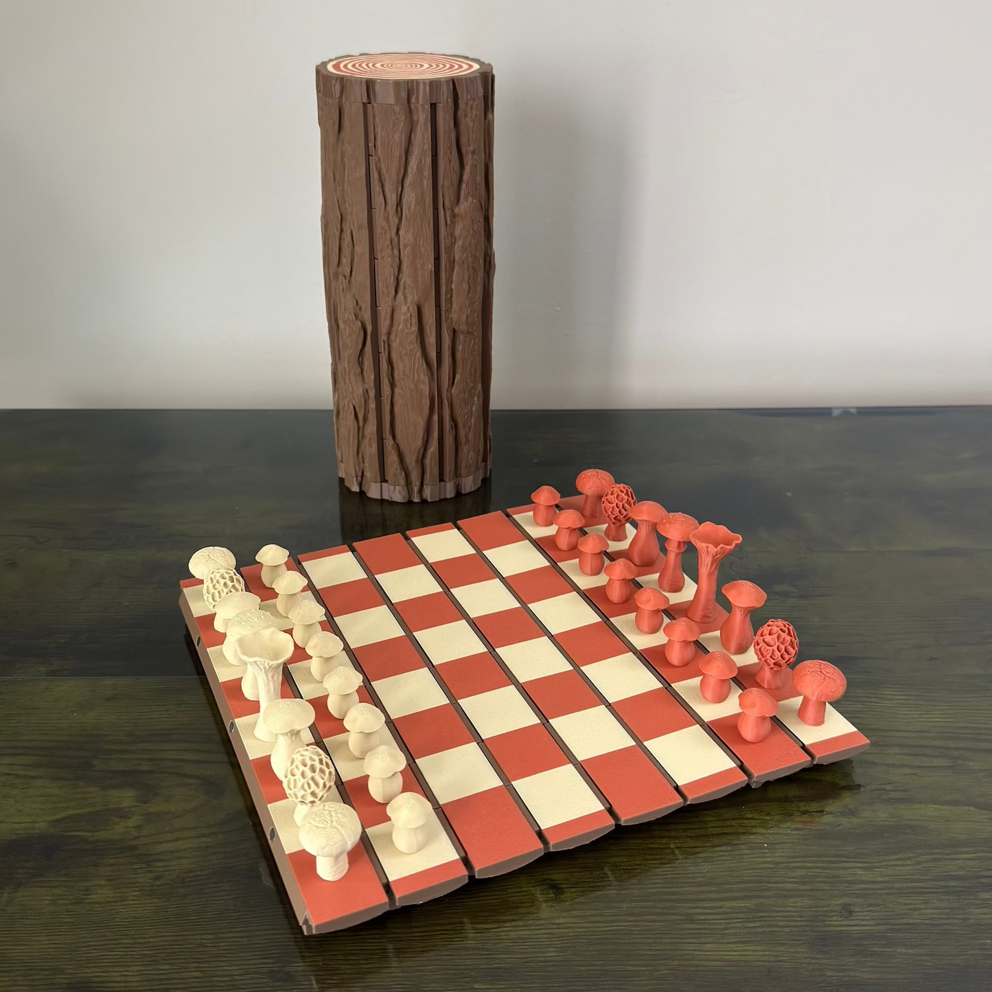 Wooden chess set with red and white pieces on a checkered board, against a plain background.