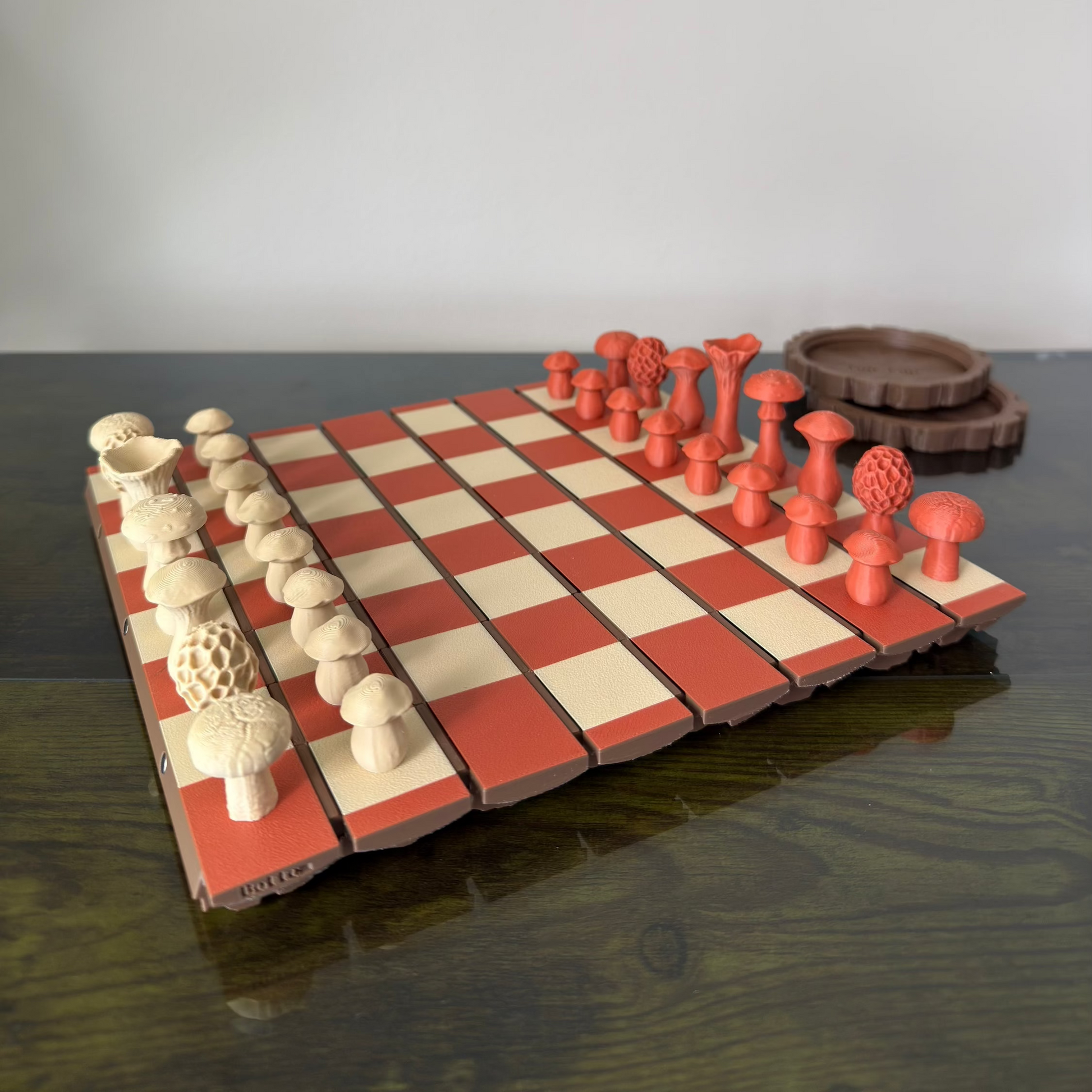 Wooden chessboard with red and white pieces on a reflective surface