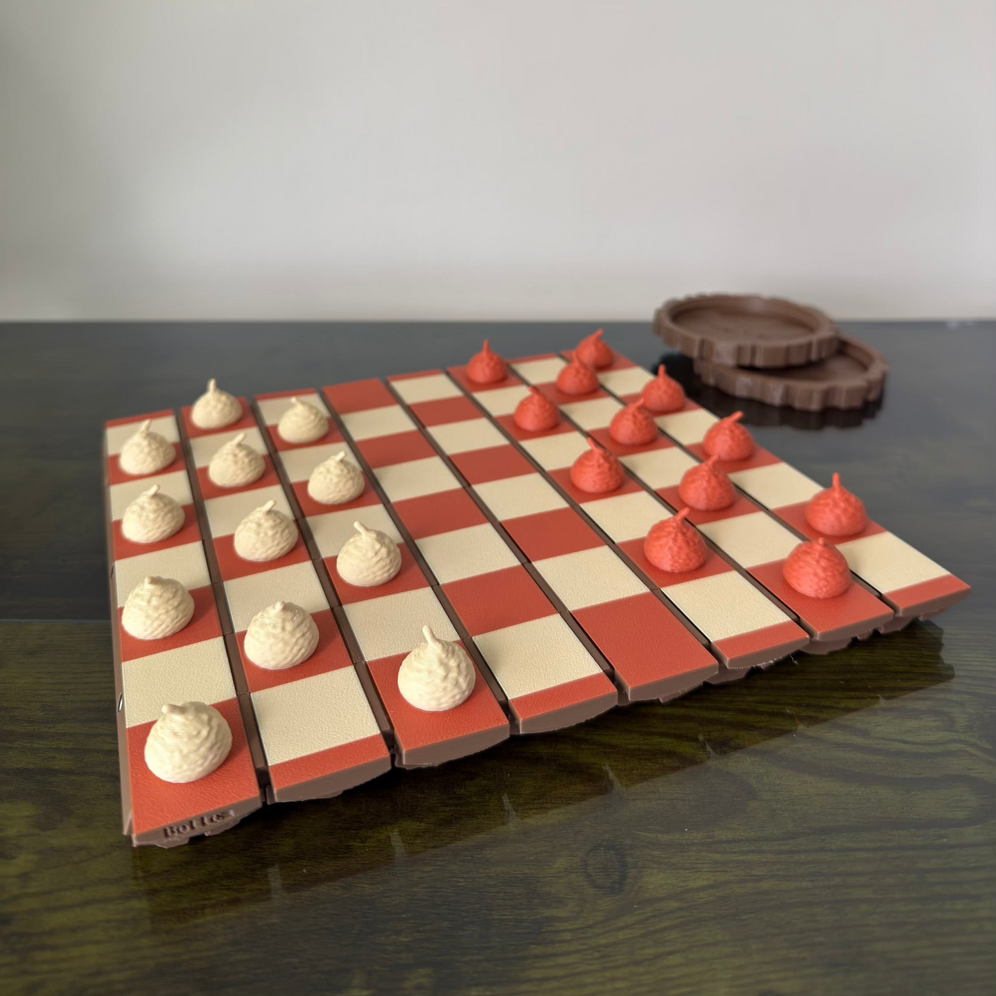 Checkered game board with red and white pieces on a dark surface