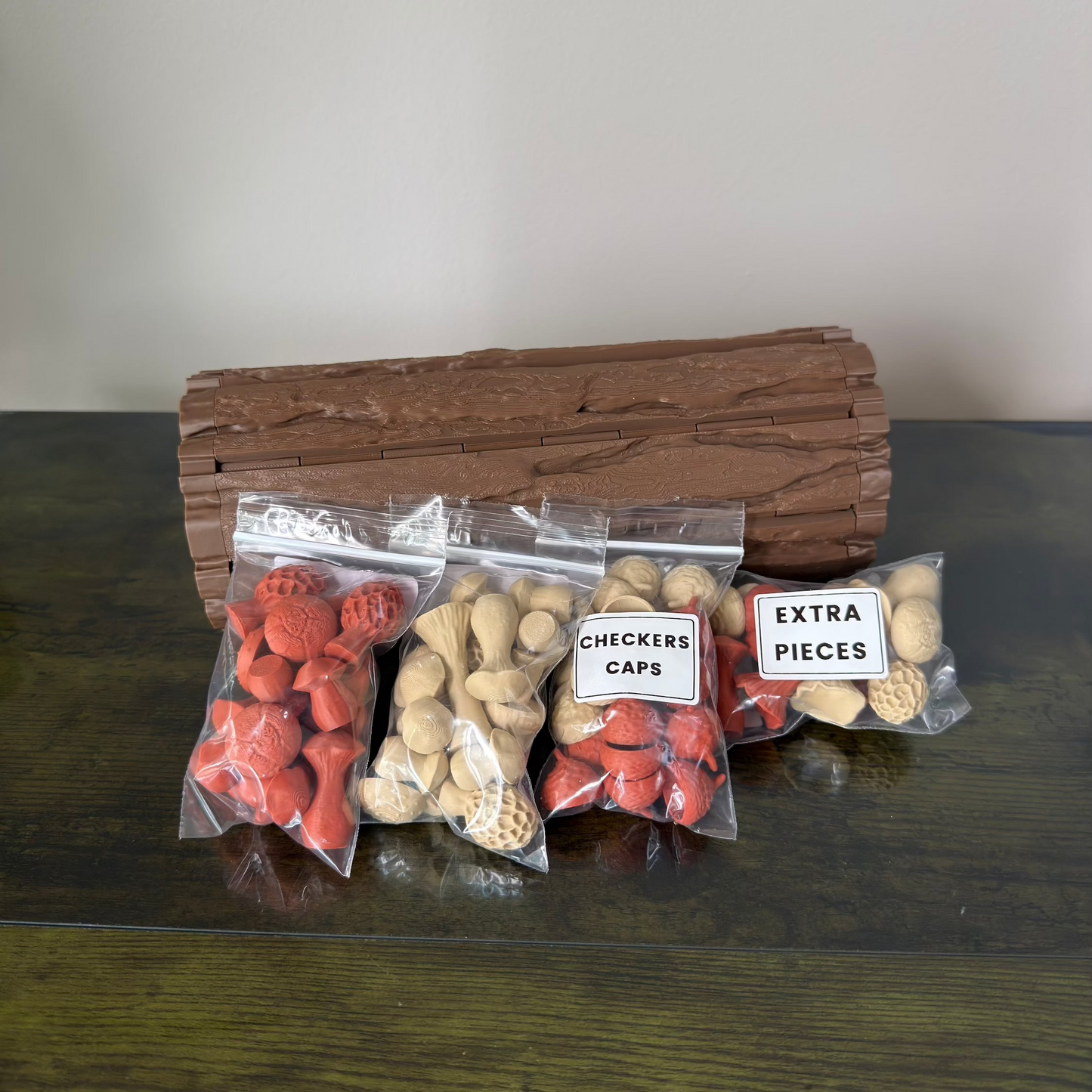 Set of game pieces including red and beige checkers caps and extra pieces on a wooden surface.